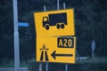 Extra direction signs in yellow for trucks for new road because drivers don`t update their navigation and was creating traffic is