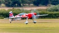 An Extra EA-300/S aerobatic display aircraft landing at airfield