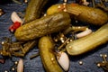 Extra Fine Cornichons - minuscule sour French pickles on natural stone background. Mini French style Gherkin Cucumbers