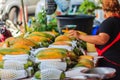 Extra jumbo size of ripe big yellow papaya fruit wrapped in protective net for sale at the fruit market in Bangkok, Thailand. Org