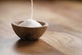 Extra sea salt pour in wood bowl on wooden table