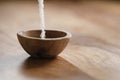 Extra sea salt pour in wood bowl on wooden table