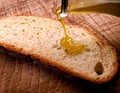 Extra virgin olive oil being drizzled onto bread Royalty Free Stock Photo