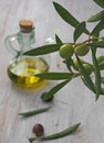 Extra-virgin olive oil bottle and green olivas