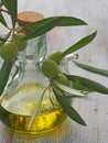Extra-virgin olive oil bottle and green olivas