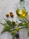 Extra-virgin olive oil bottle and green olivas Royalty Free Stock Photo