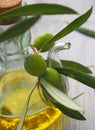 Extra-virgin olive oil bottle and green olivas Royalty Free Stock Photo