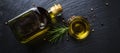 Extra virgin olive oil in a glass bottle, rosemary and peppercorns Royalty Free Stock Photo