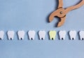 Extracting caries tooth from healthy teeth row