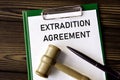 EXTRADITION AGREEMENT - words on a white sheet with a judge\'s gavel