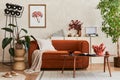 Extraordinary living room interior composition with retro designed sofa, wooden coffee table, industrial lamp, plants and stylish.