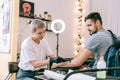 Extraordinary short-haired tattoo master shaving off hair from hand