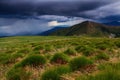 Extraordinary stormy sky with rain clouds is spanned over the high mountain. Royalty Free Stock Photo