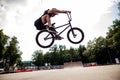 Boy jumping with his street-bike bmx in skate park Royalty Free Stock Photo