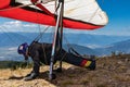 Extremal man with hang-glider preparing to fly Royalty Free Stock Photo