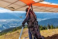 Extremal man with hang-glider preparing to fly Royalty Free Stock Photo