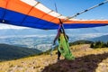 Extremal man with hang-glider preparing to fly Royalty Free Stock Photo