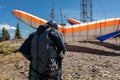 Extremal man with hang-glider preparing to fly