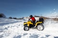 Extremal rider drive his ATV 4wd quad bike stand in heavy snow with deep wheel track. Motion and dynamic image.