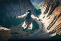 Extreme athlete membranes jumps from a cliff canyon in a mountainous area with a river at the bottom. Generative AI technology