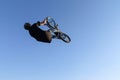 Extreme biker black t-shirt, blue jeans and a helmet, doing a so