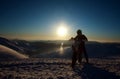 Extreme biker on sport motorcycle on winter snow mountain on sky