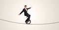 Extreme business man riding unicycle on a rope Royalty Free Stock Photo