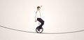 Extreme business man riding unicycle on a rope Royalty Free Stock Photo