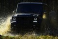 Extreme, challenge and 4x4 vehicle concept. SUV or offroad car on path covered with grass crossing puddle with water Royalty Free Stock Photo