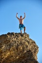 Extreme Climber Raising Hands