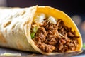 Extreme close-up of a beef taco on a plate, showing the juicy and tender meat filling, the crispy and slightly charred shell