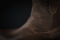 Extreme close-up of a brown leather cowboy boot on black Royalty Free Stock Photo