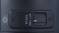 Extreme close up of camera lens details. Action. Manual MF and auto AF focus switch button on and off on the side of Royalty Free Stock Photo