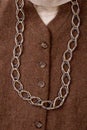Extreme close up chain necklace on brown coat. Royalty Free Stock Photo