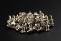 Extreme close up of different types of computer case screws on black background. Selective focus, very shallow depth of field Royalty Free Stock Photo