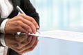 Extreme close up of female hand signing document.