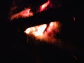Extreme close up of fire sparks moving on dark night sky as black background coming from brightly burning warm outdoors Royalty Free Stock Photo