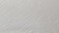 An extreme close-up of a freshly painted wall or ceiling with a subtle diagonal brushstroke pattern. The surface is light Royalty Free Stock Photo