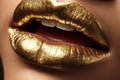 Extreme close-up of full female lips in golden glitter paint. Decorative cosmetics for women. Gold lipgloss dripping