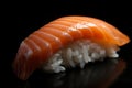 Extreme close-up of glistening salmon nigiri with a thin slice of fish draped over a bed of rice