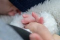 Extreme close up of the hand of little baby holding mothers hand with his little fingers Royalty Free Stock Photo