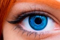 Extreme Close Up Of Human Blue Eye of red-haired woman Royalty Free Stock Photo