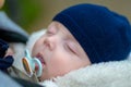 Extreme close up of little baby sleeping with a pacifier and a blue hat Royalty Free Stock Photo