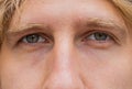 Extreme close-up macro portrait of young face, redhead man's eyes looking at camera, smiling Royalty Free Stock Photo