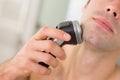 Extreme Close up of man shaving with electric razor