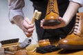 Extreme Close Up of Mans Hands Cleaning Luxury Calf Leather Brogues