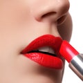 Extreme close up on model applying red lipstick. Makeup. Professional fashion retro make-up. Red lipstick.