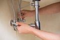 Extreme Close up of a plumber's hands and washbasin drain Royalty Free Stock Photo