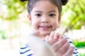 Extreme close up portrait of an adorable cute little girl. Funny kid with the big eyes in the garden. Happy beautiful kid looking Royalty Free Stock Photo