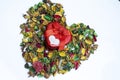 Close up of A red heart metal gift box on colorful dried flowers used as wallpaper Royalty Free Stock Photo